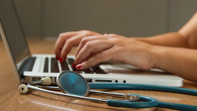 Someone typing on a laptop