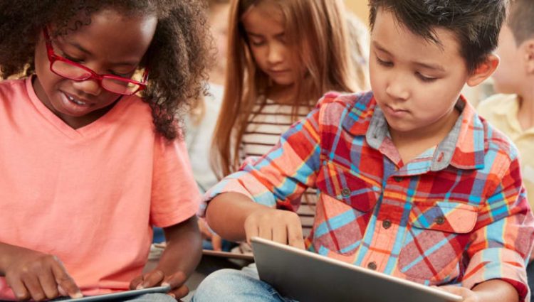 Photo of Young children using tablets