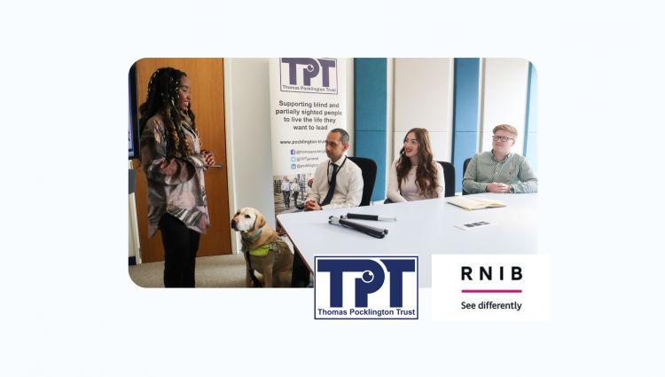 A picture of two young men and a woman sitting around a table in a meeting room. They are all listening to a young lady standing and delivering a presentation. Next to her, there is a guide dog standing. TPT's banner is behind them. TPT and RNIB logos on bottom right