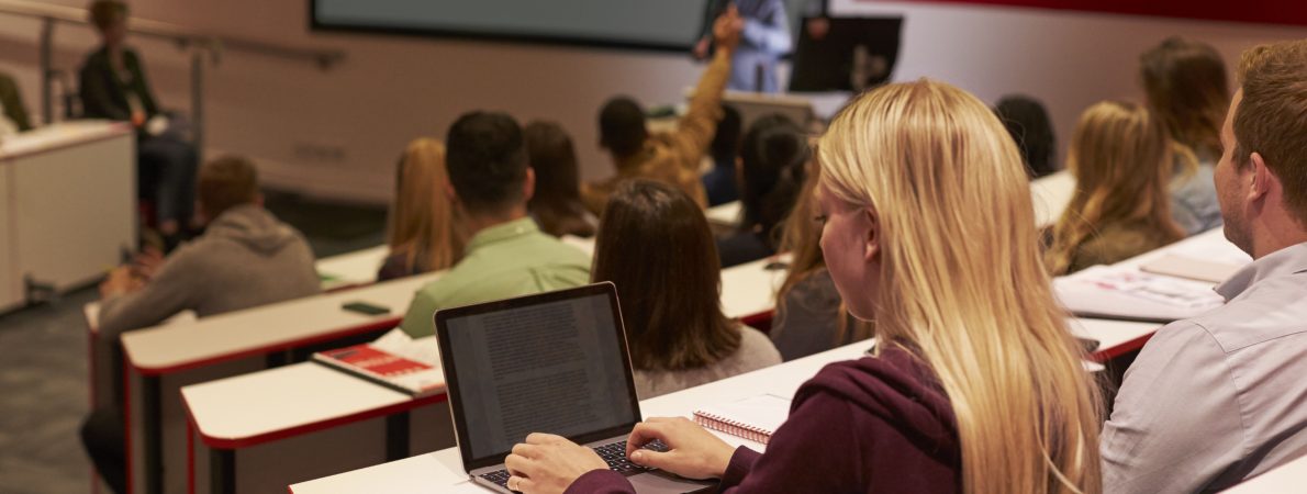 Student in front of her laptop in a lecture theatre