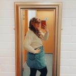 Phoebe taking a selfie in front of a mirror