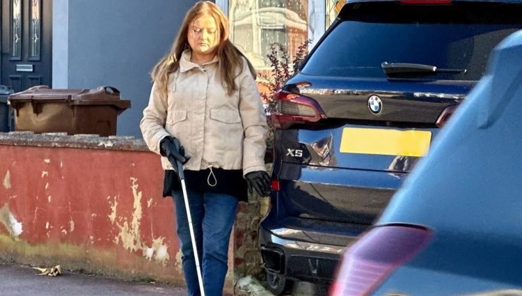 Blind lady trying to navigate around a large 4 by 4 vehicle which is dangerously parked, forcing into the road.