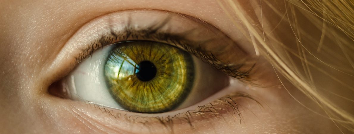 Close up image of a blonde woman's green eye