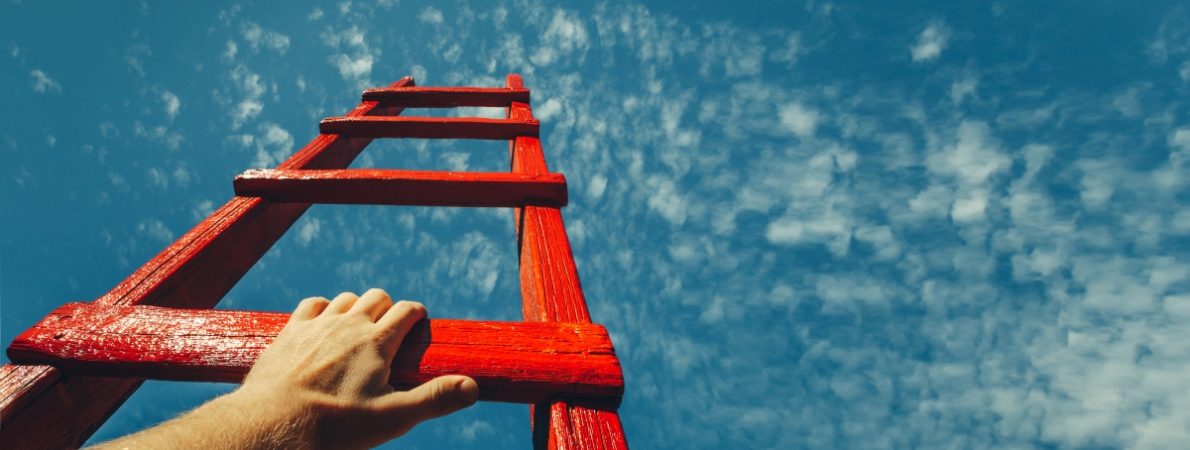 Man's Hand Reaching For Red Ladder Leading To A Blue Sky Shutterstock 24 lr