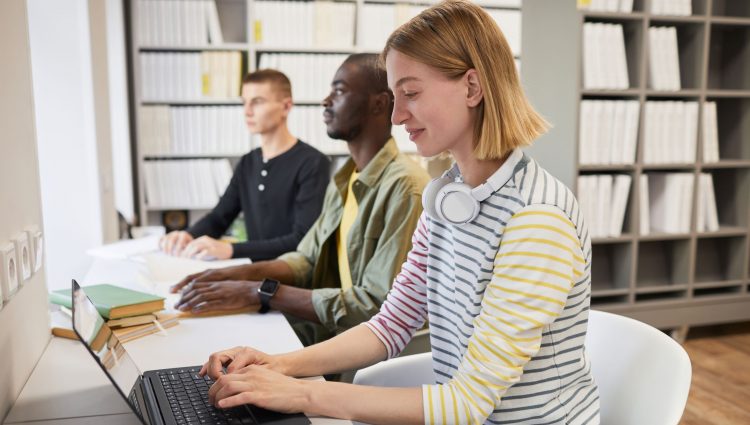 Three students working in the library