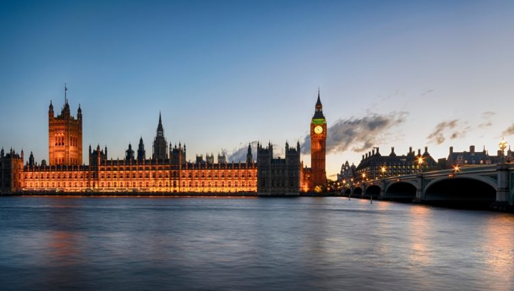 Image shows façade of Houses of Parliament taken from across the river Thames