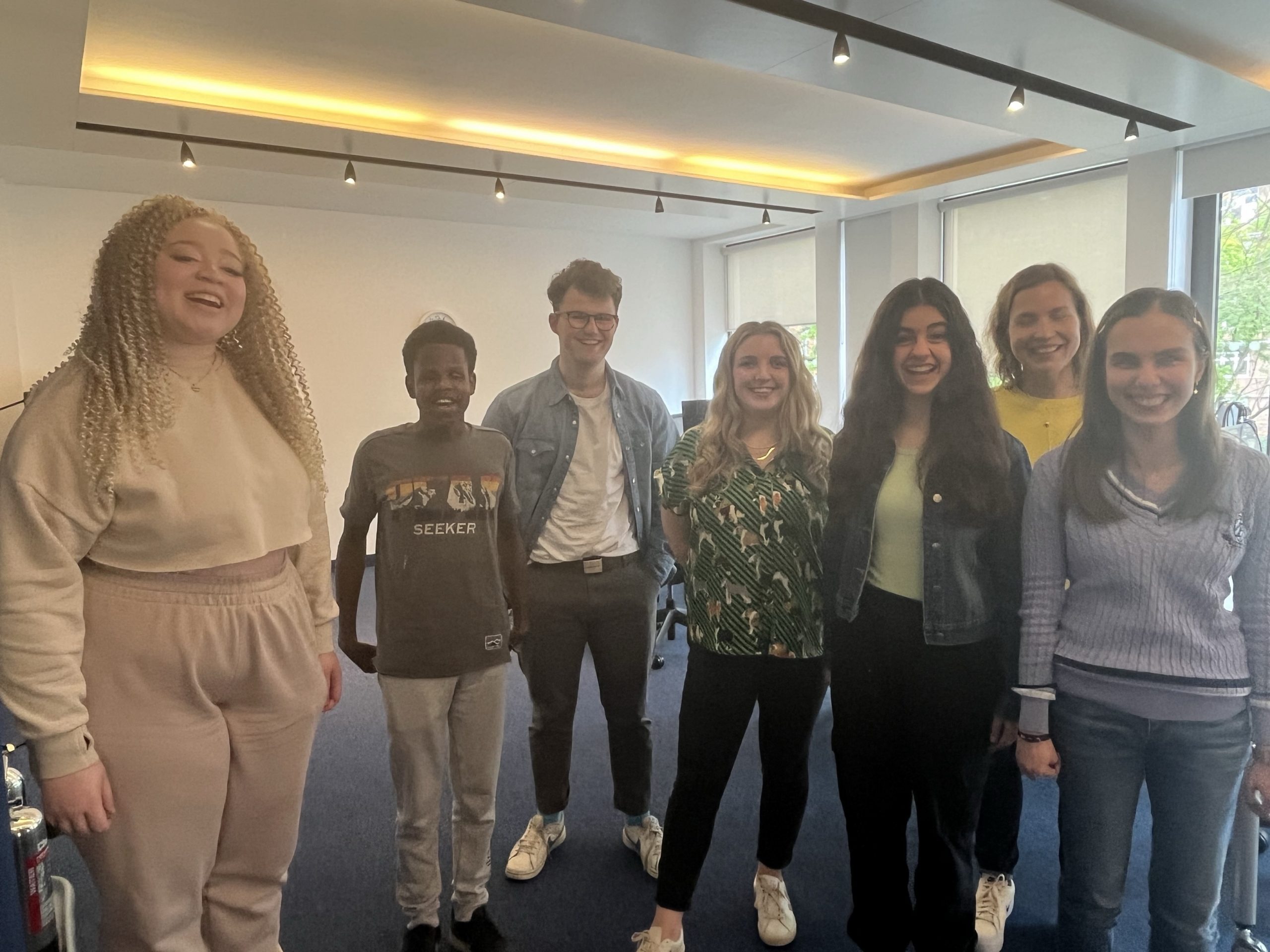 Our Young Voices group with TPT's Student Participation Manager smiling at the camera.