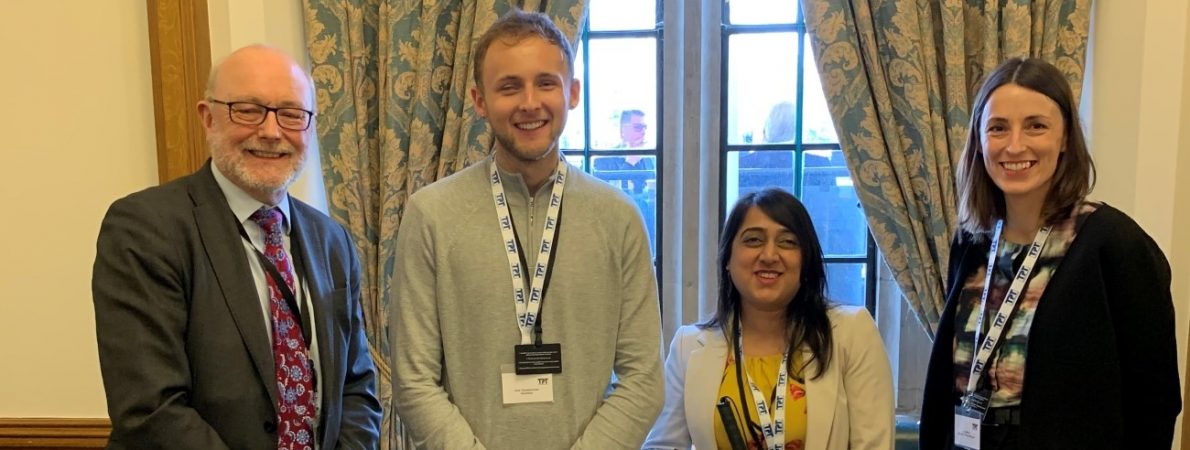 Aleks with two members of TPT's Education team and an MP looking at