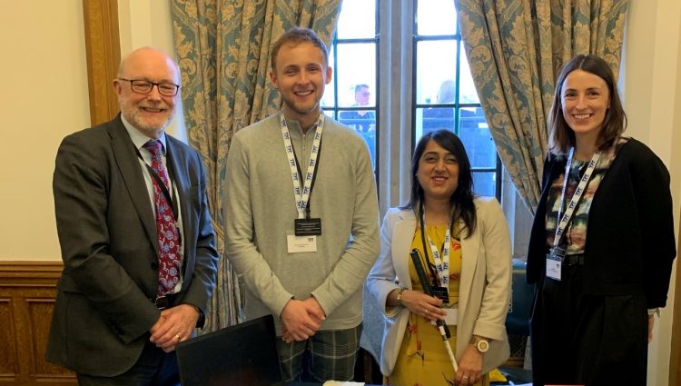 Aleks with two members of TPT's Education team and an MP looking at