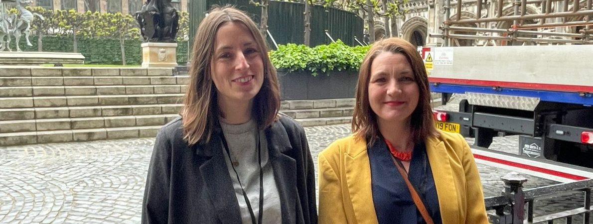 Tara Chattaway on the right and Lucy Merritt on the left, outside the Parliament.