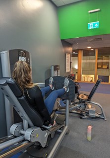 Belle using the equipment in the gym.
