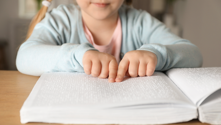 Blind child reading braille
