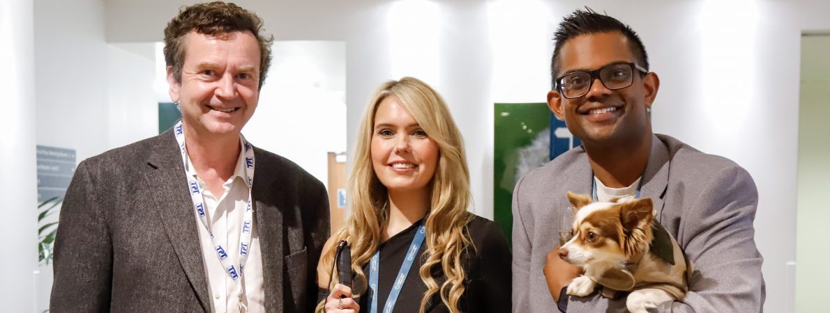 TPT CEO Charles Colquhoun (left) with Claire Sisk (centre) and a male colleague who is holding a small chihuahua