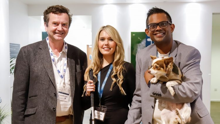 TPT CEO Charles Colquhoun (left) with Claire Sisk (centre) and a male colleague who is holding a small chihuahua
