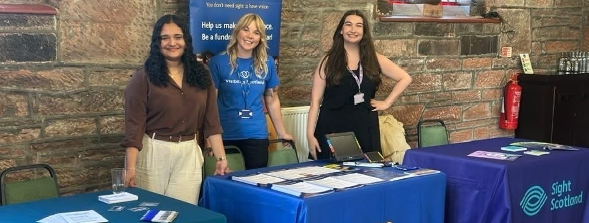 Picture standing Francesca Munoz, Steph Nicholson and Zara Grew stand behind their respective stalls of Sight Loss Councils, Visibility Scotland and Sight Scotland.