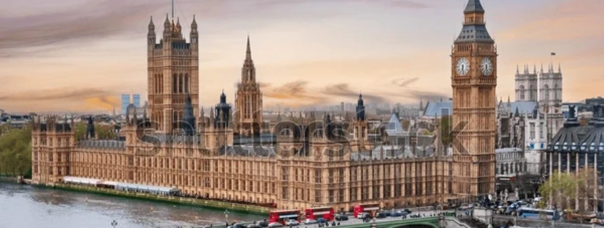 A picture of the House of Parliament overlooking the river Thames and a bridge.