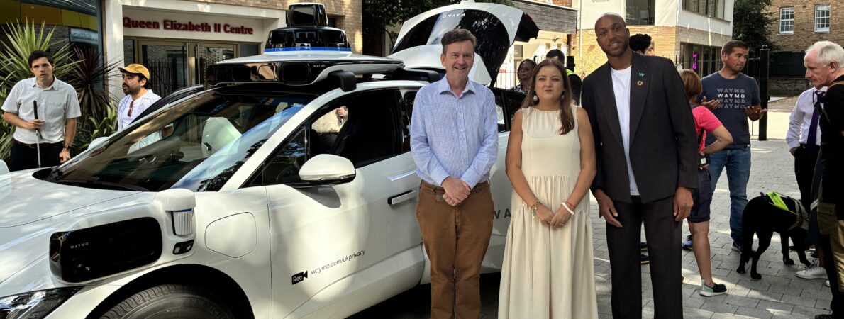 TPT Chief Executive Charles Colquhoun, TPT Policy and Campaigns Manager Bhavini Makwana and Waymo representative Nathan Ashley standing in front of the Waymo car.